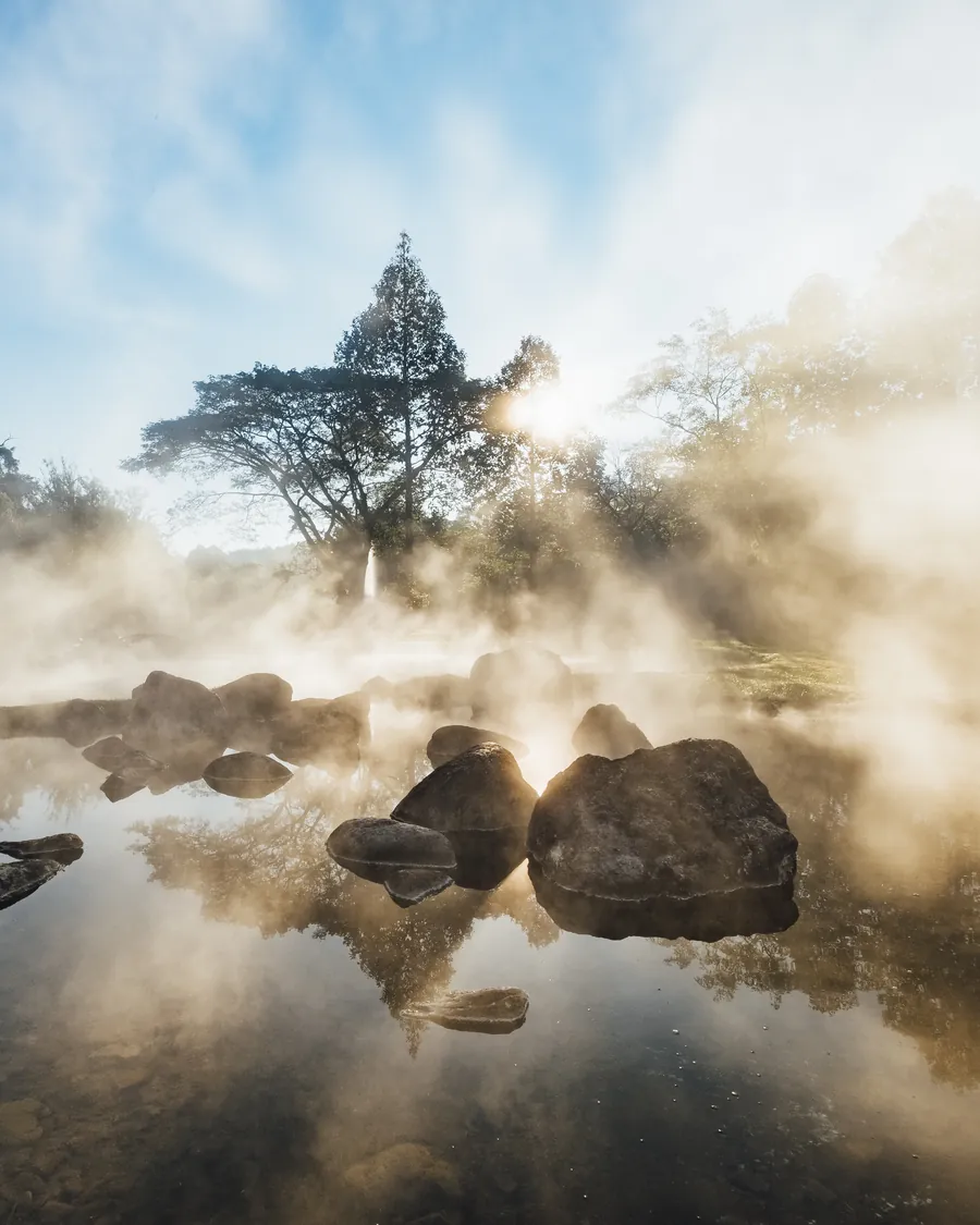 Morning mist rising over a peaceful natural spring